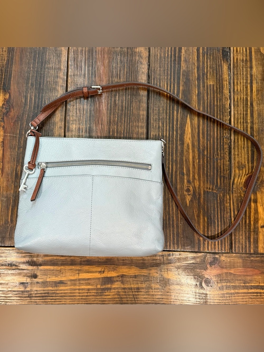 Fossil crossbody bag in light blue-gray / pale slate blue.